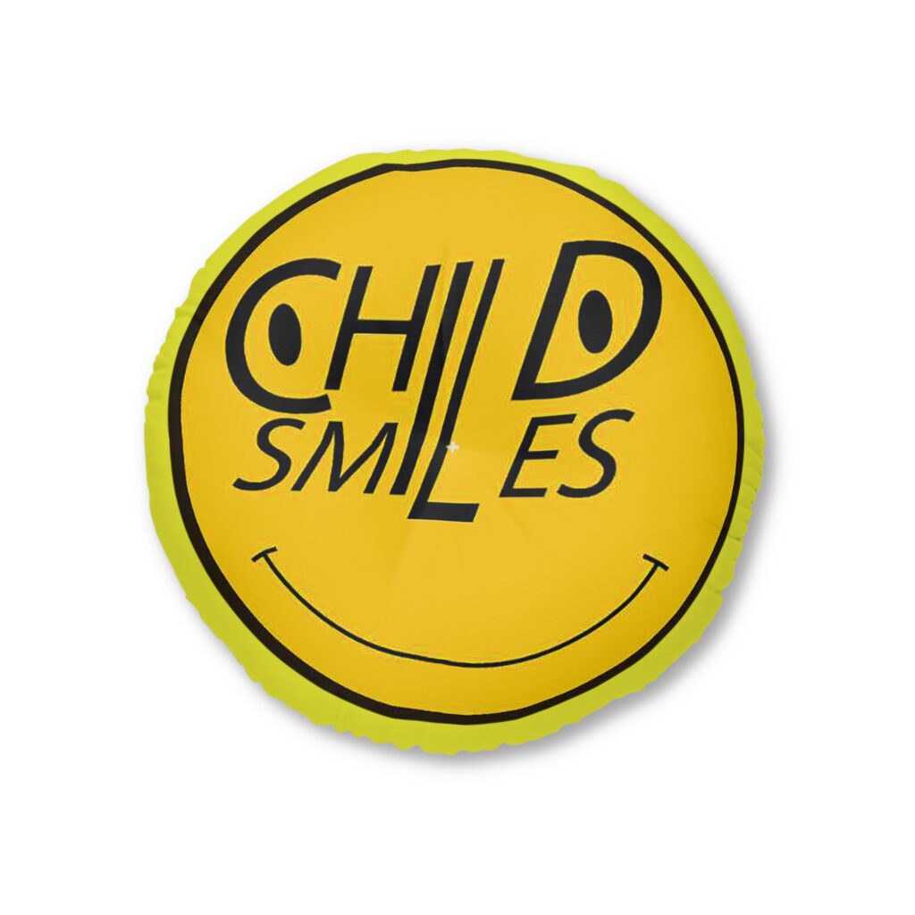 round tufted floor pillow — "child smiles" yellow graphic accent cushion